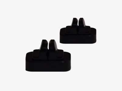 Two black LEGO bricks with curved studs, spaced apart on a white background (top-down view).